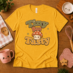 Tiny But Tasty cute food graphic t-shirt cozy flat lay in gold.
