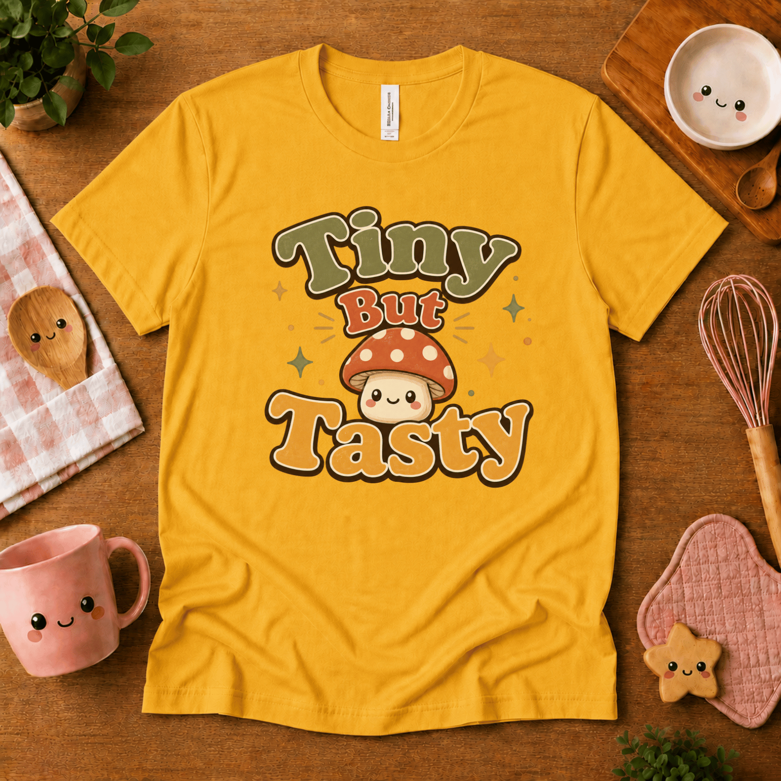 Tiny But Tasty cute food graphic t-shirt cozy flat lay in gold.