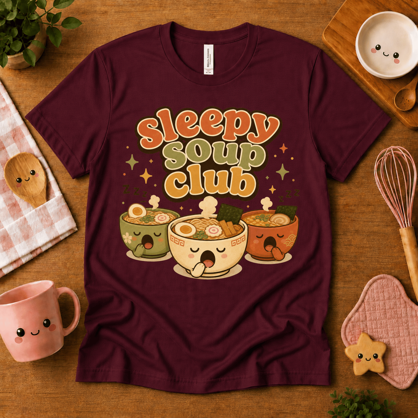 Sleepy Soup Club cute food graphic t-shirt cozy flat lay in maroon.