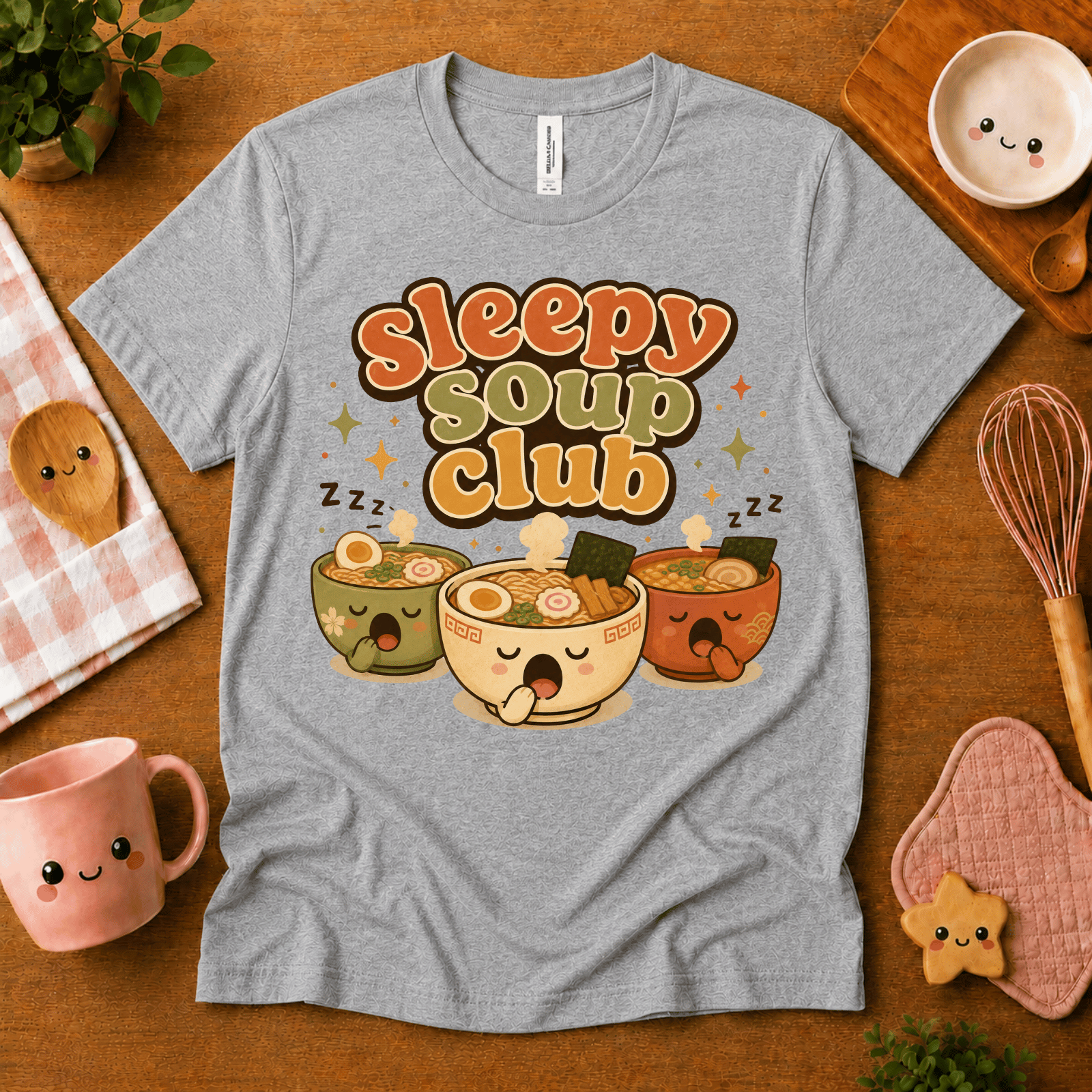 Sleepy Soup Club cute food graphic t-shirt cozy flat lay in athletic heather.
