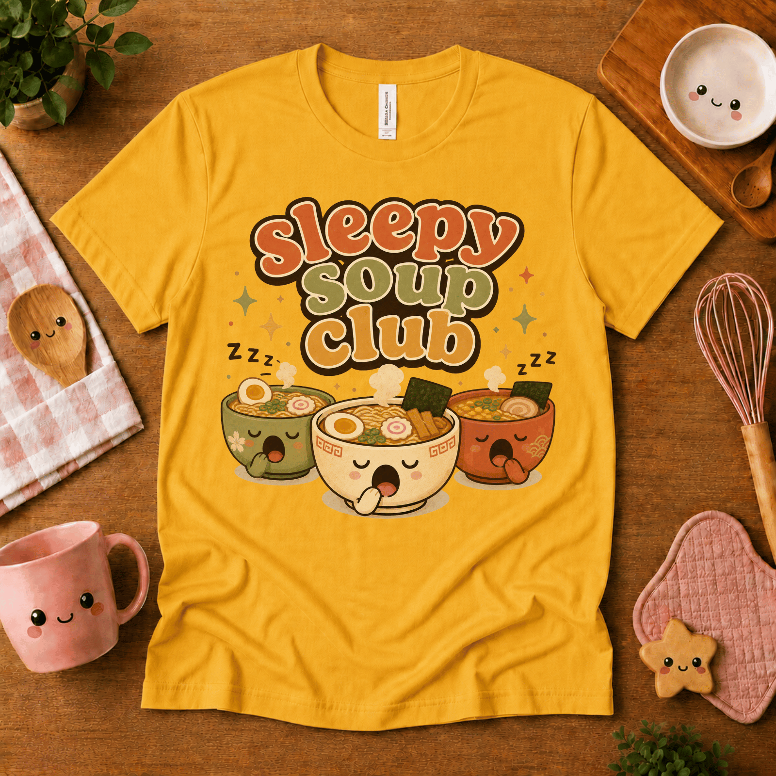 Sleepy Soup Club cute food graphic t-shirt cozy flat lay in gold.