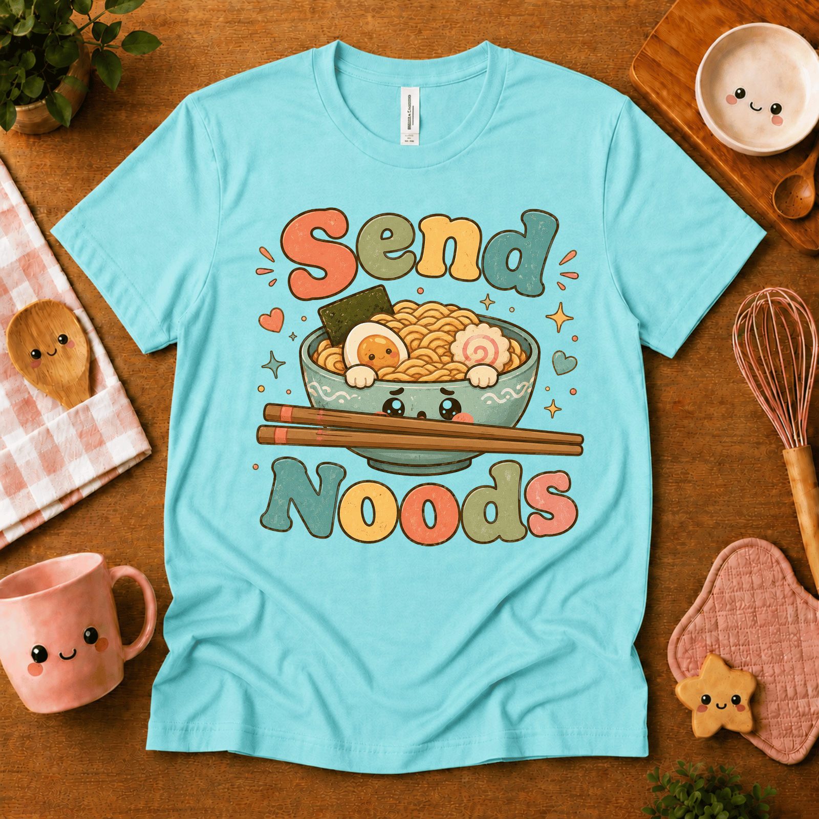 Send Noods cute food graphic t-shirt cozy flat lay in aqua.