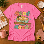 Send Noods cute food graphic t-shirt cozy flat lay in charity pink.