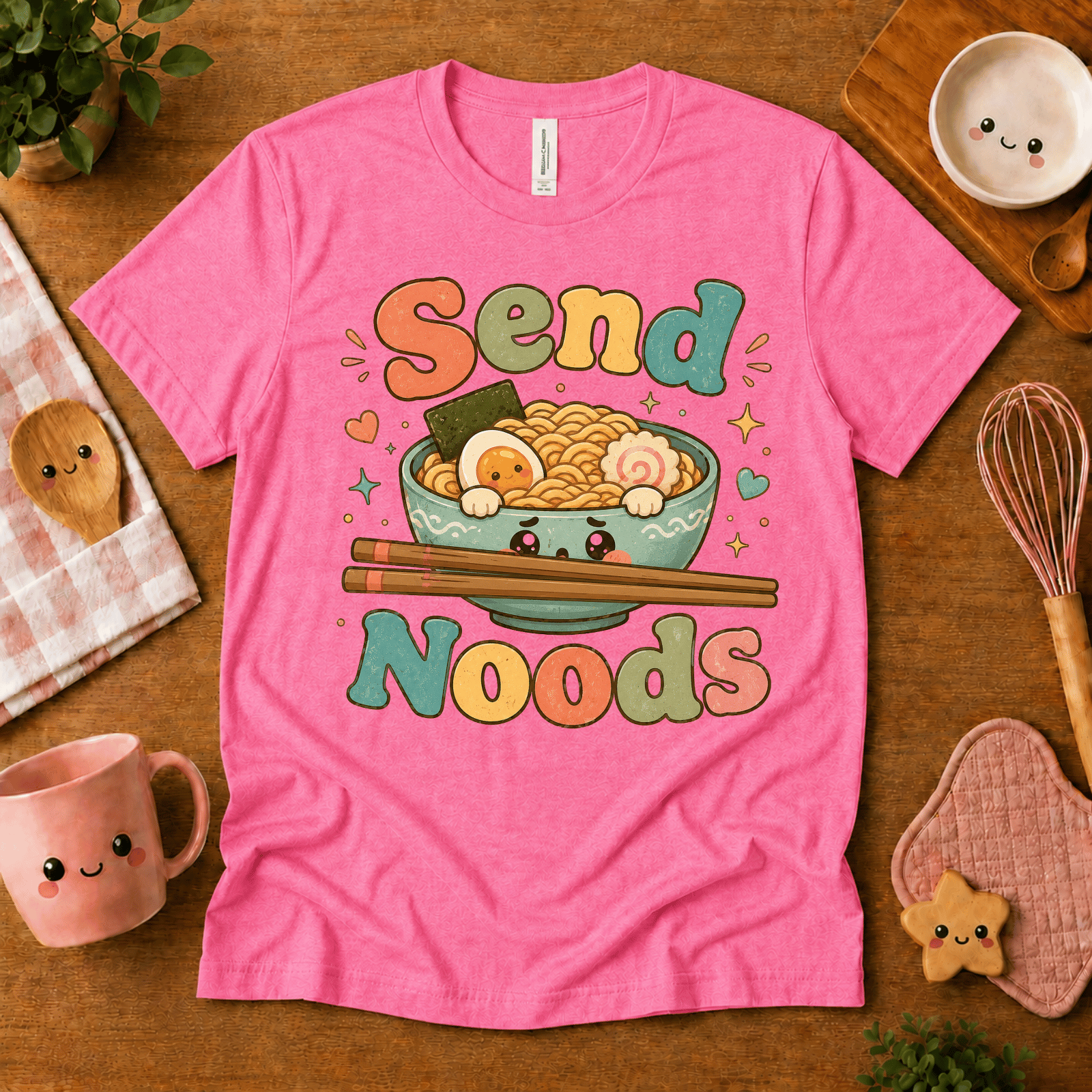 Send Noods cute food graphic t-shirt cozy flat lay in charity pink.