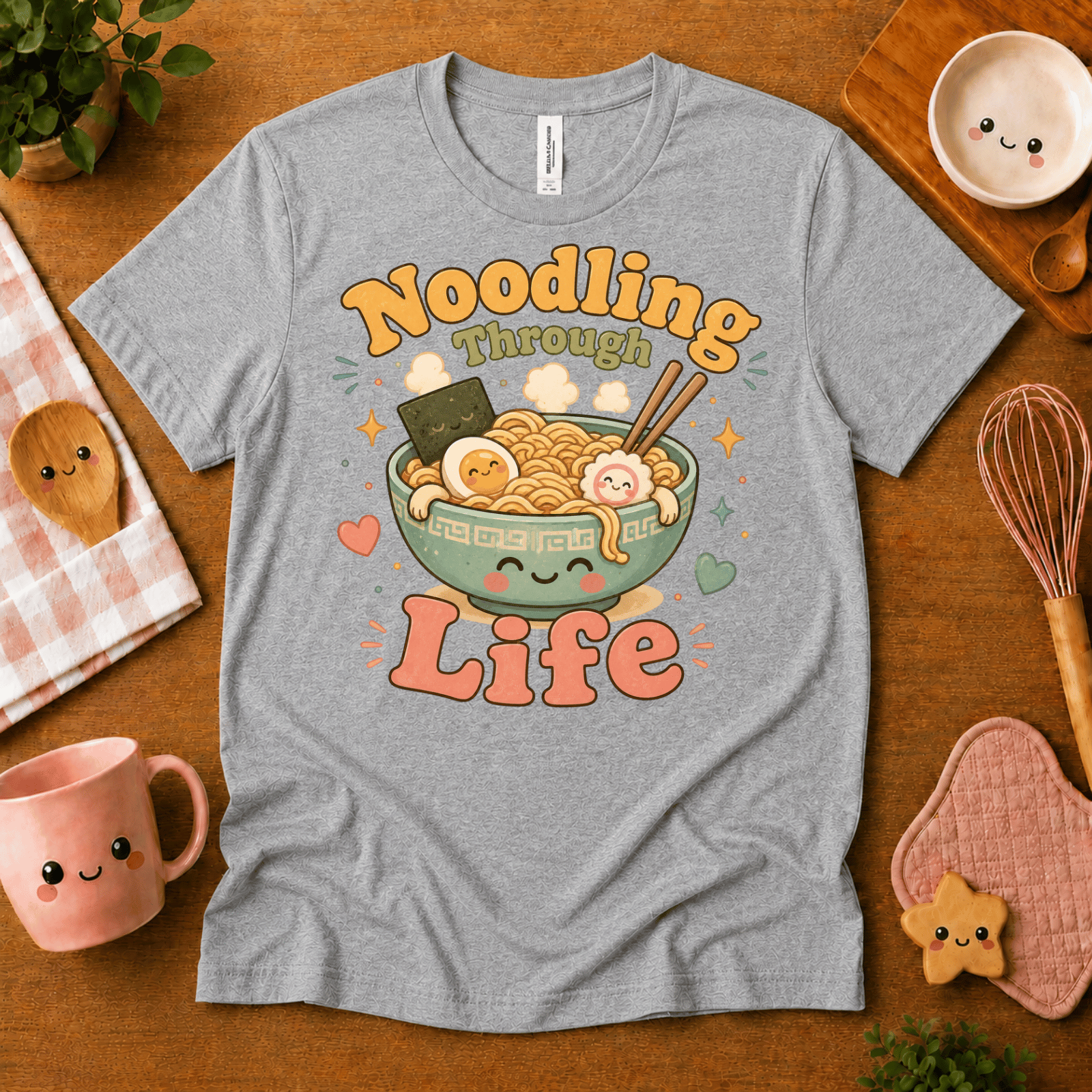 Noodling Through Life cute food graphic t-shirt cozy flat lay in athletic heather.