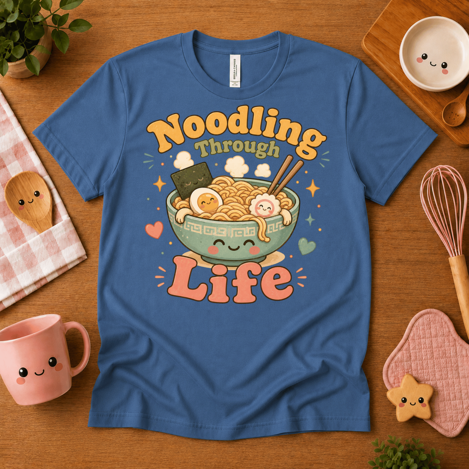 Noodling Through Life cute food graphic t-shirt cozy flat lay in steel blue.