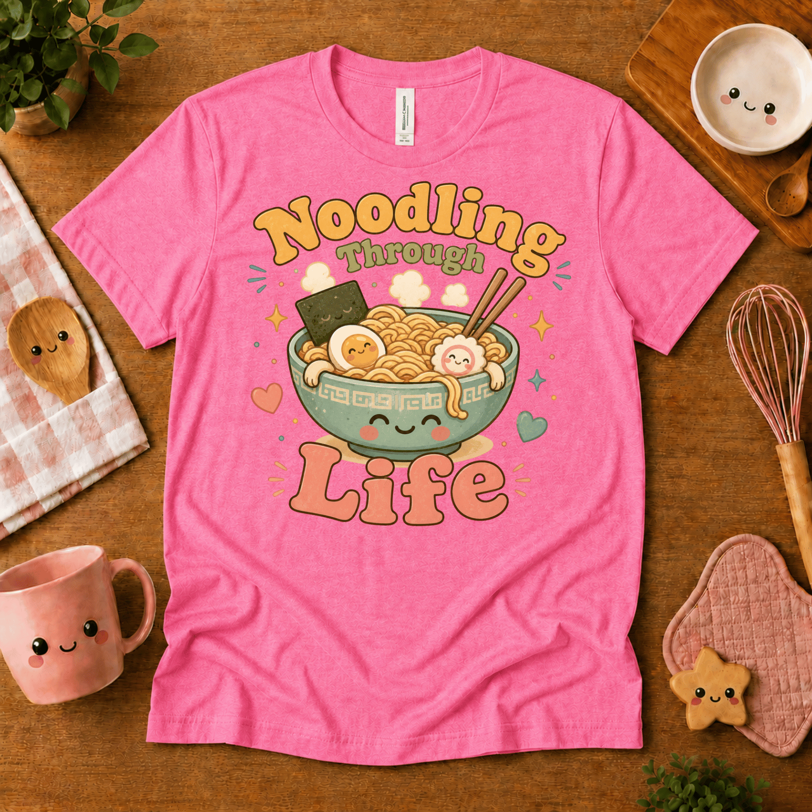 Noodling Through Life cute food graphic t-shirt cozy flat lay in charity pink.