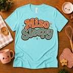 Miso Sleepy cute food graphic t-shirt cozy flat lay in aqua.