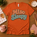 Miso Sleepy cute food graphic t-shirt cozy flat lay in burnt orange.