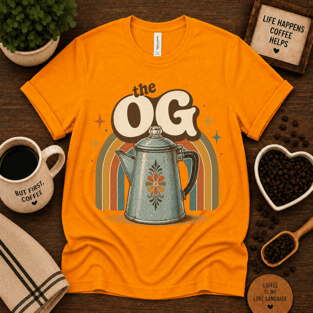 The OG coffee graphic t-shirt cozy flat lay in gold.