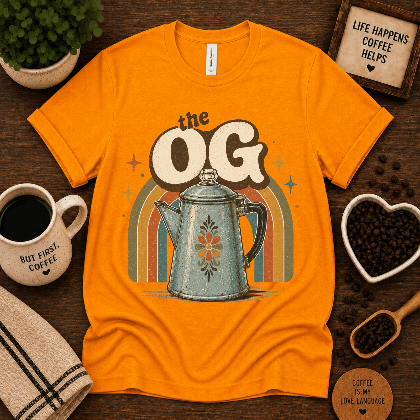 The OG coffee graphic t-shirt cozy flat lay in gold.
