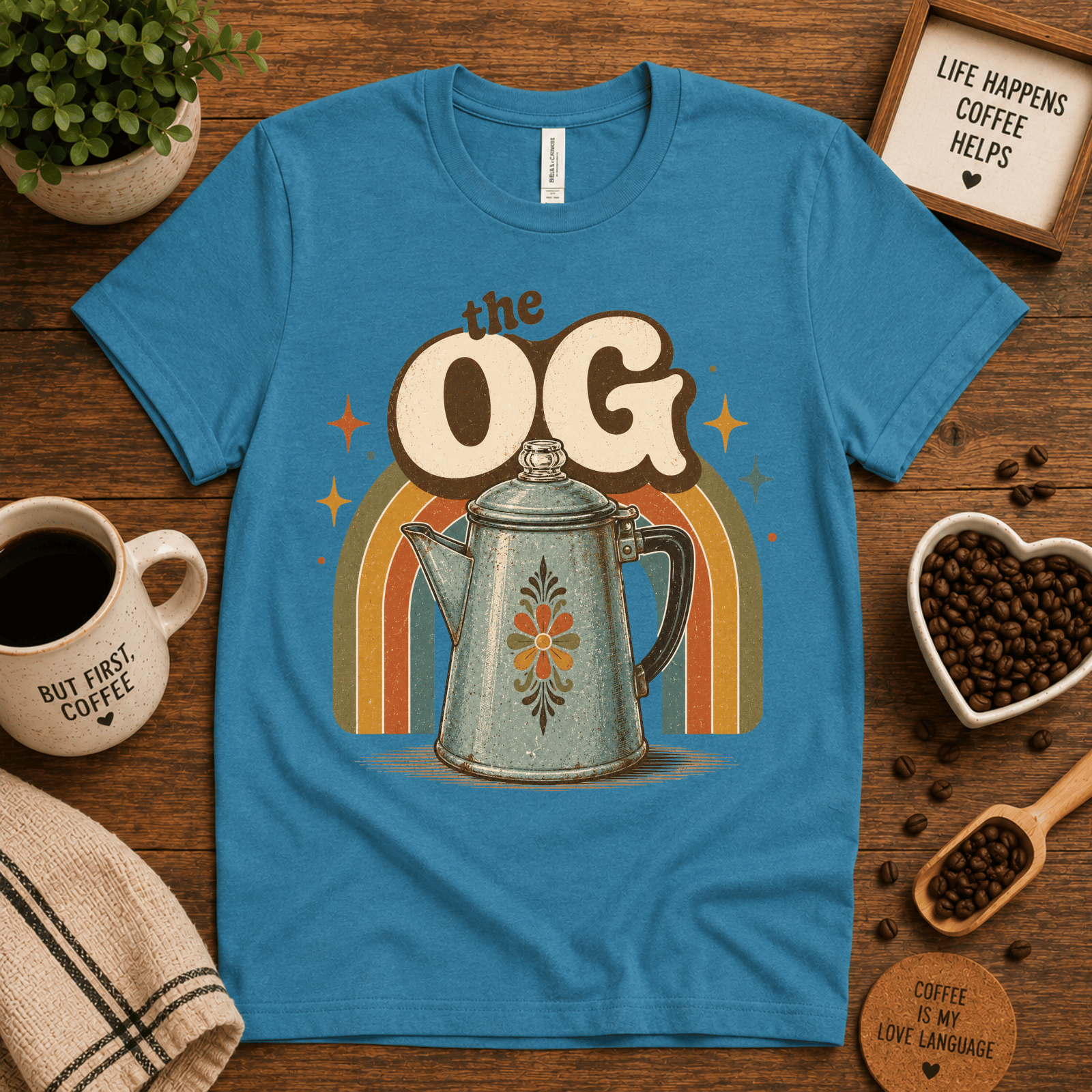 The OG coffee graphic t-shirt cozy flat lay in aqua.