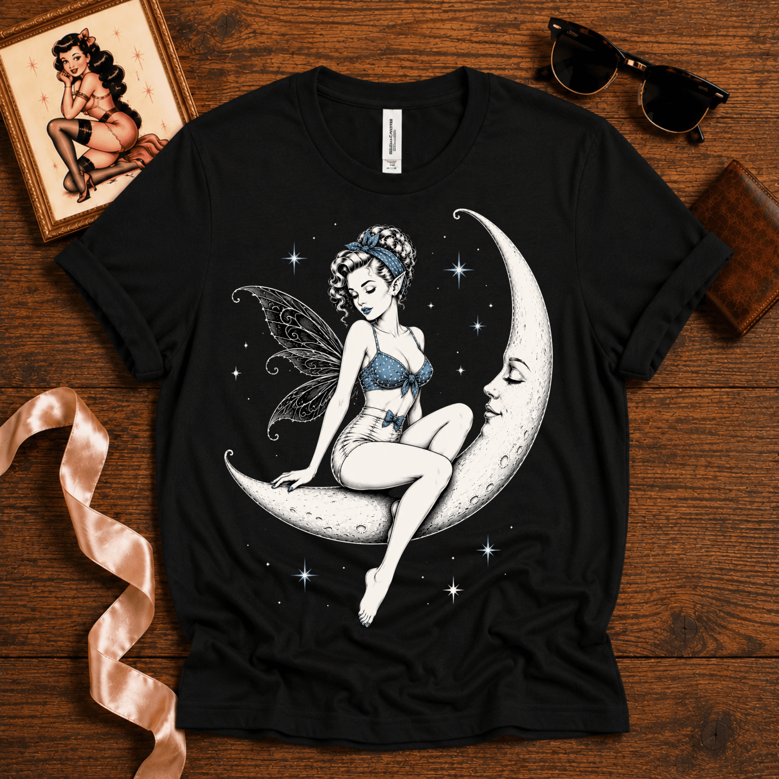 Moonlit Fairy pinup graphic t-shirt cozy flat lay in vintage black.