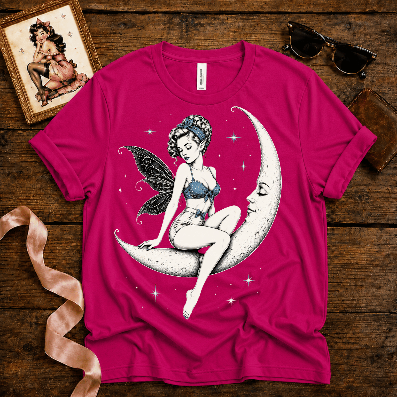 Moonlit Fairy pinup graphic t-shirt cozy flat lay in charity pink.