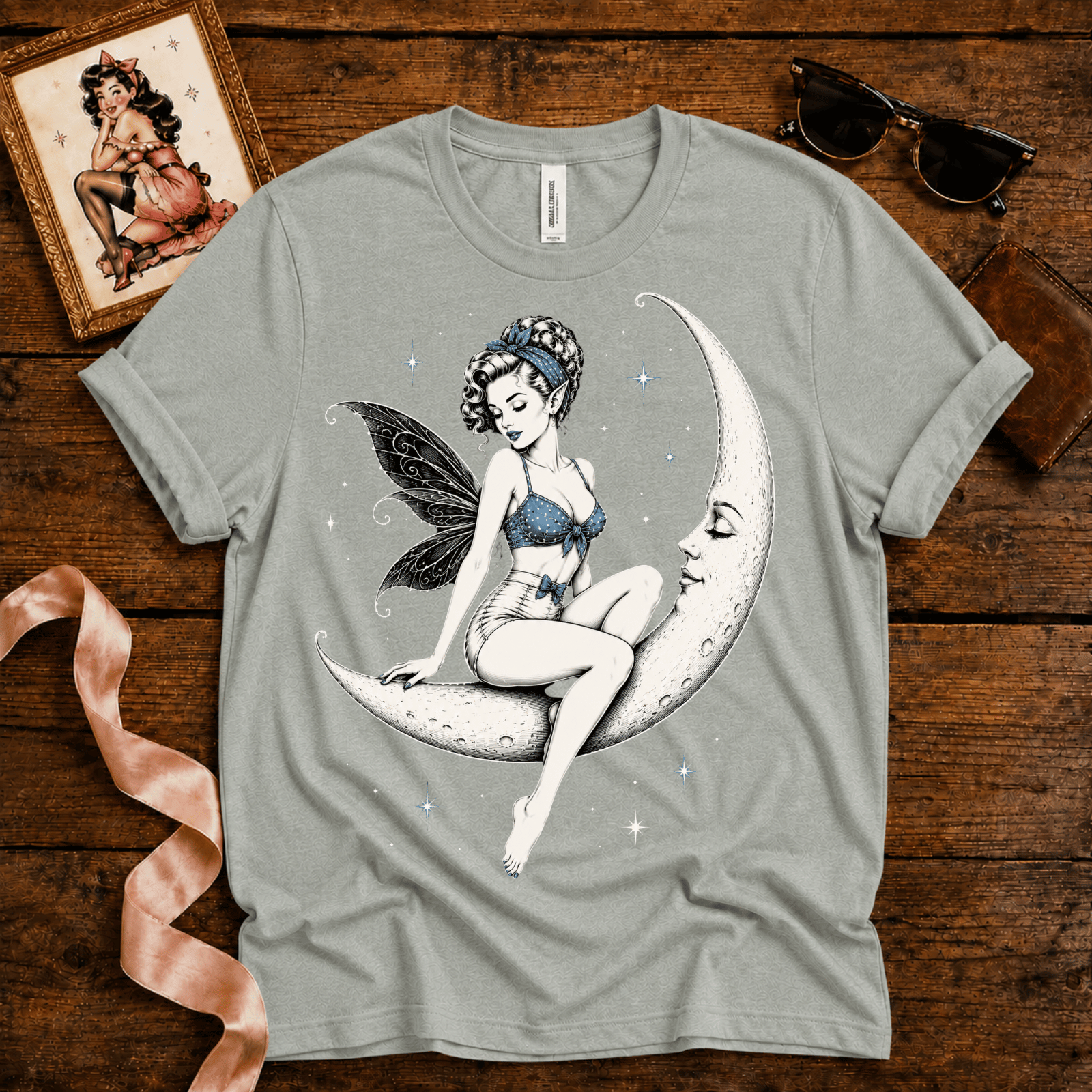 Moonlit Fairy pinup graphic t-shirt cozy flat lay in athletic heather.