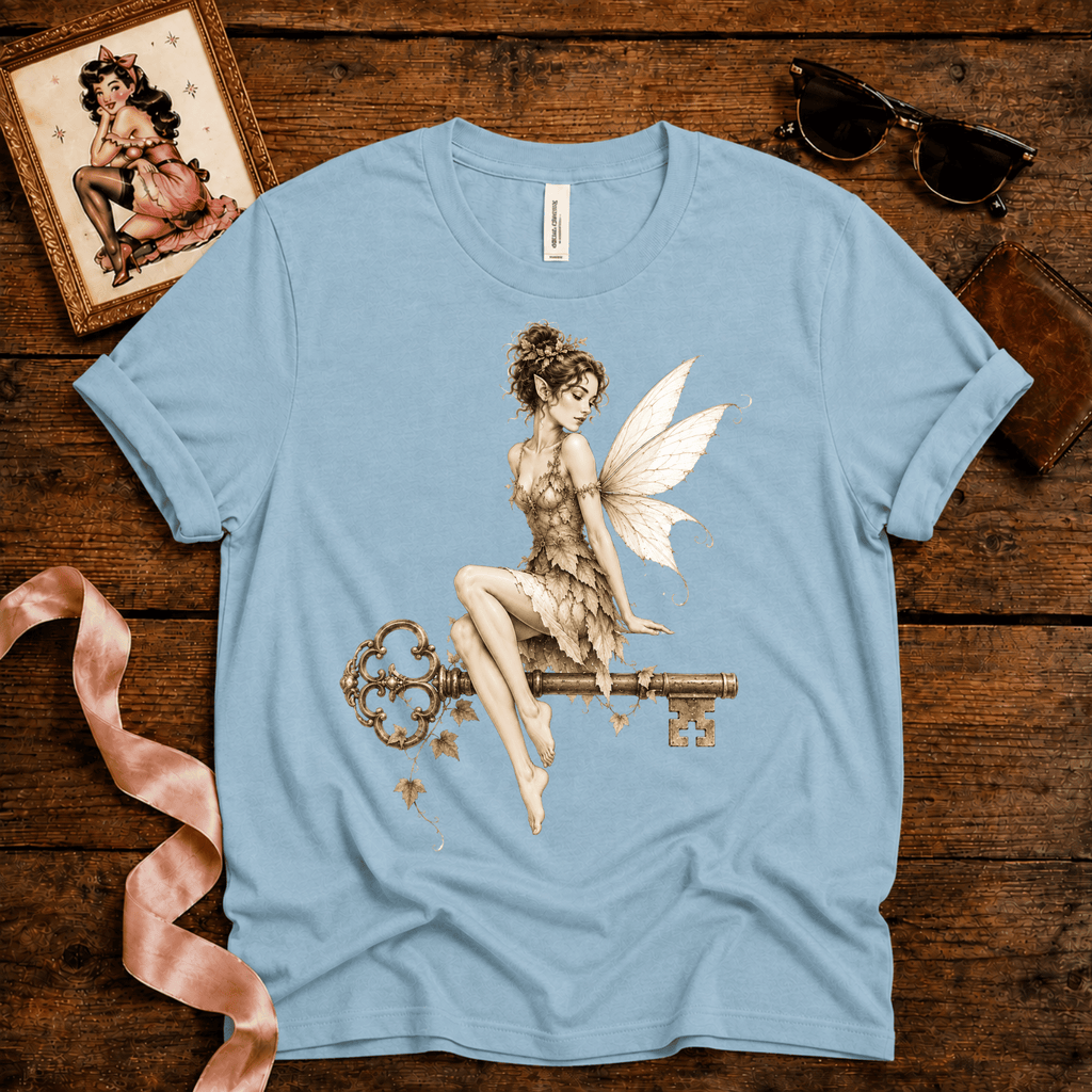 Fairy Key pinup graphic t-shirt cozy flat lay in baby blue.