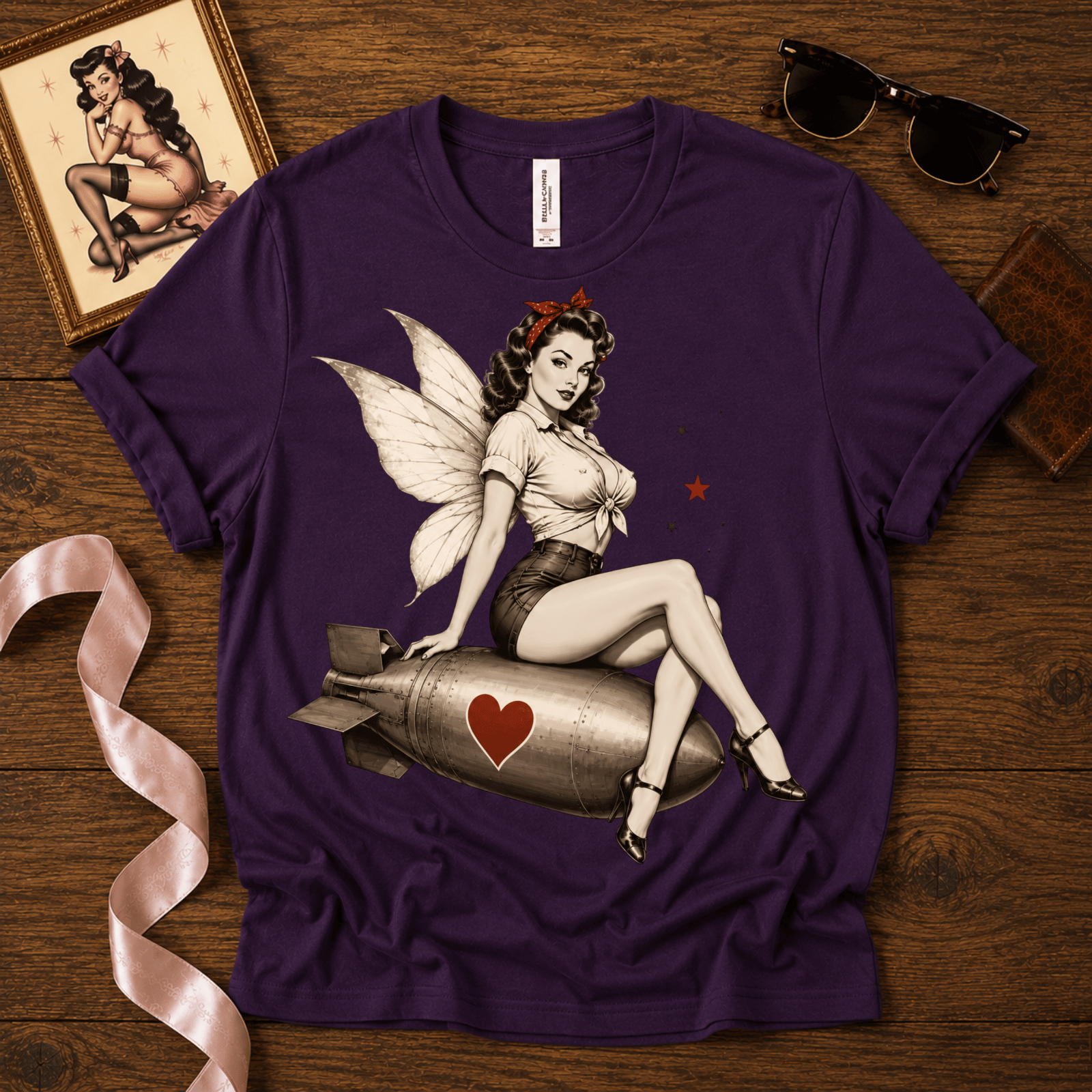 Love Bomb pinup fairy graphic t-shirt cozy flat lay in team purple.