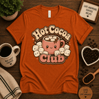 Hot Cocoa Club coffee graphic t-shirt cozy flat lay in burnt orange.