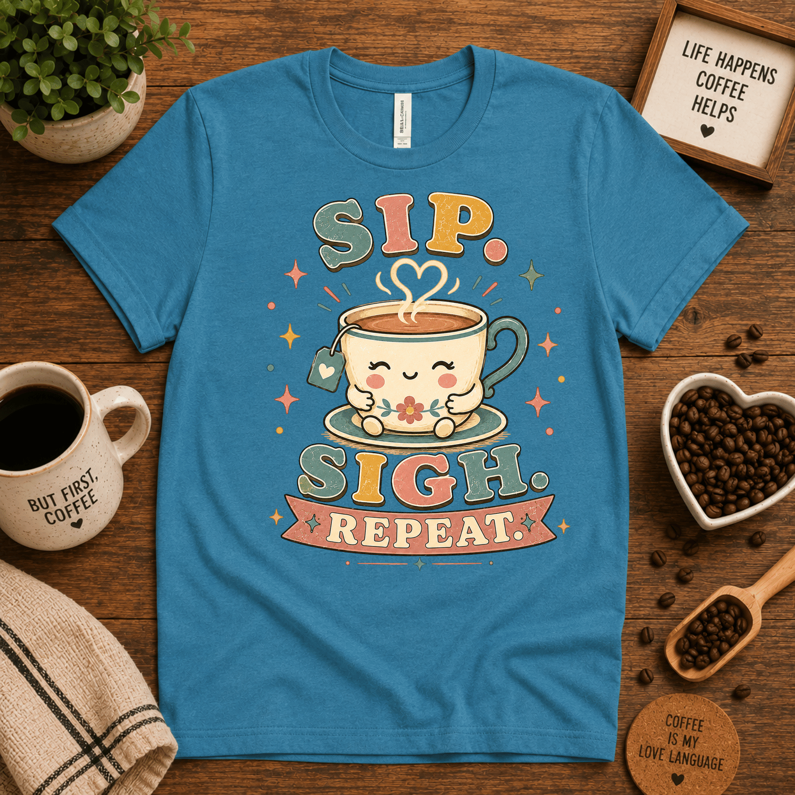 Sip. Sigh. Repeat. coffee graphic t-shirt cozy flat lay in aqua.