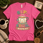 Sip. Sigh. Repeat. coffee graphic t-shirt cozy flat lay in charity pink.