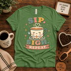 Sip. Sigh. Repeat. coffee graphic t-shirt cozy flat lay in leaf.