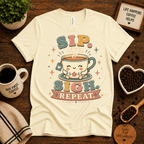 Sip. Sigh. Repeat. coffee graphic t-shirt cozy flat lay in natural.