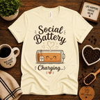 Social Battery of Tea graphic t-shirt cozy flat lay in natural.