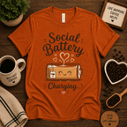 Social Battery of Tea graphic t-shirt cozy flat lay in burnt orange.
