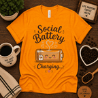 Social Battery of Tea graphic t-shirt cozy flat lay in gold.