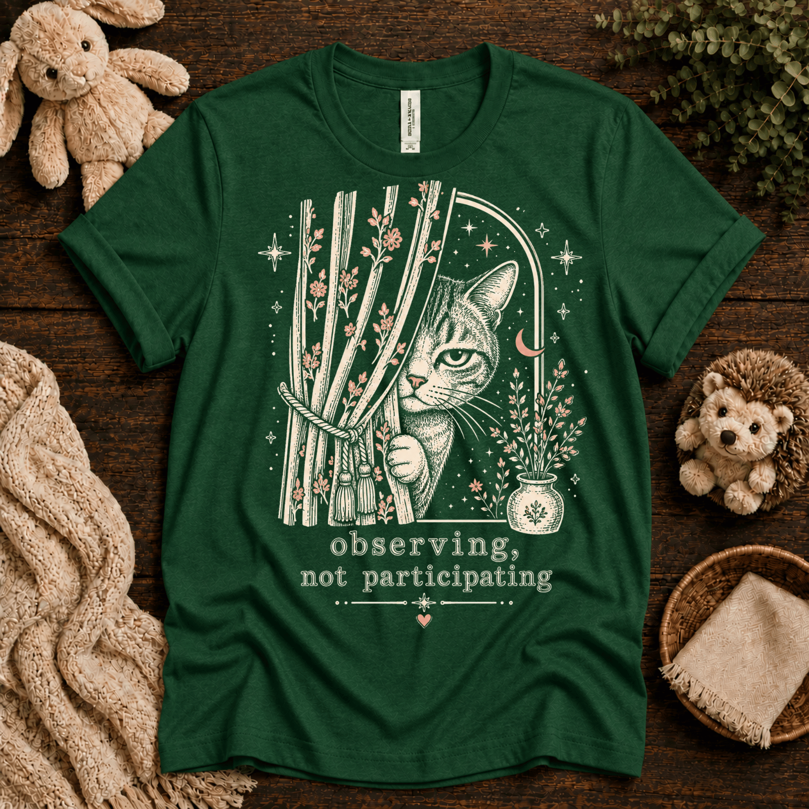 Cat Observing cute animal graphic t-shirt cozy flat lay in evergreen.