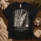 Cat Observing cute animal graphic t-shirt cozy flat lay in vintage black.