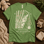 Cat Observing cute animal graphic t-shirt cozy flat lay in leaf.