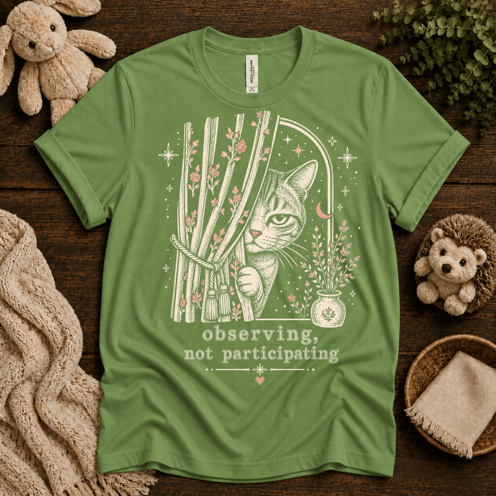Cat Observing cute animal graphic t-shirt cozy flat lay in leaf.