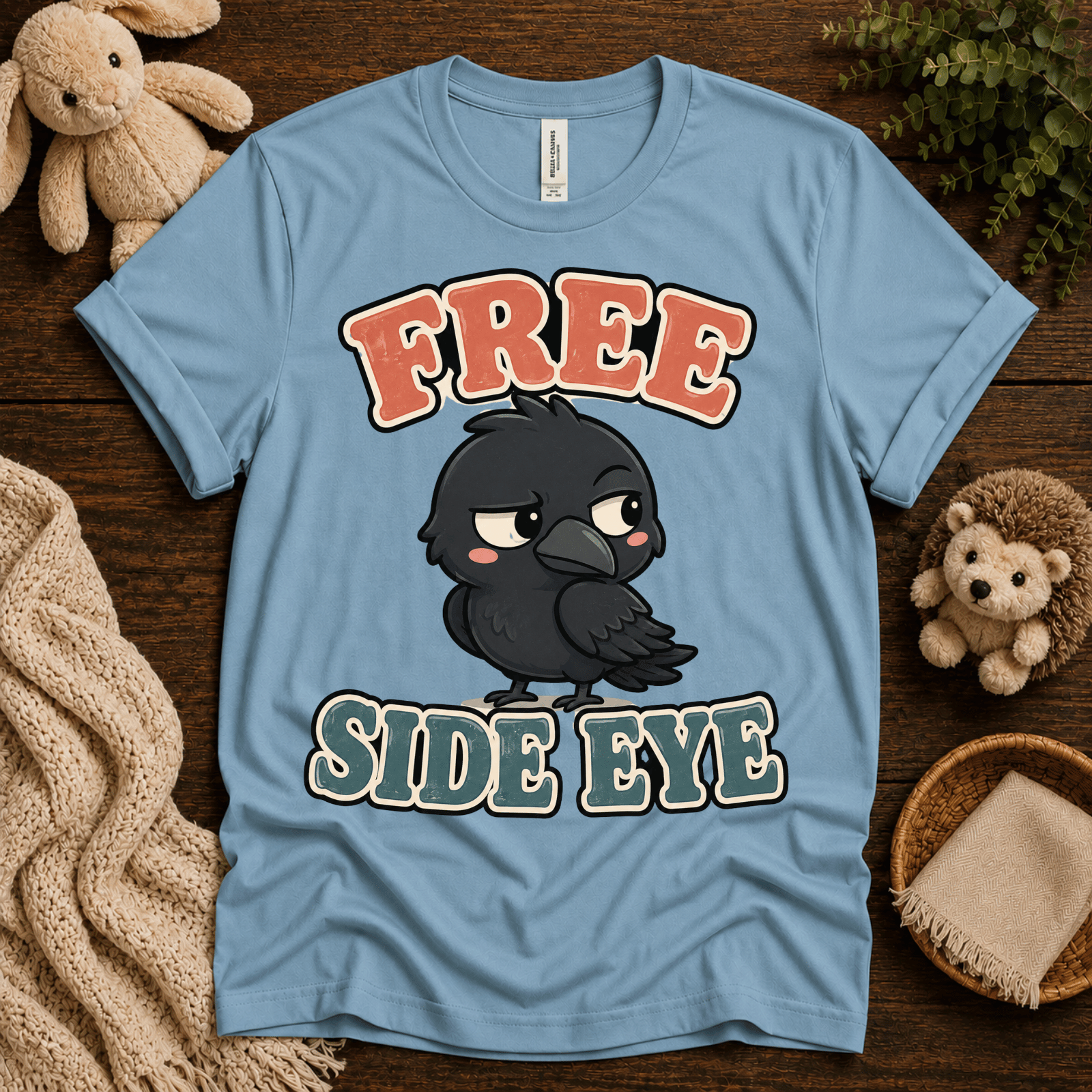 Free Side Eye cute animal graphic t-shirt cozy flat lay in baby blue.