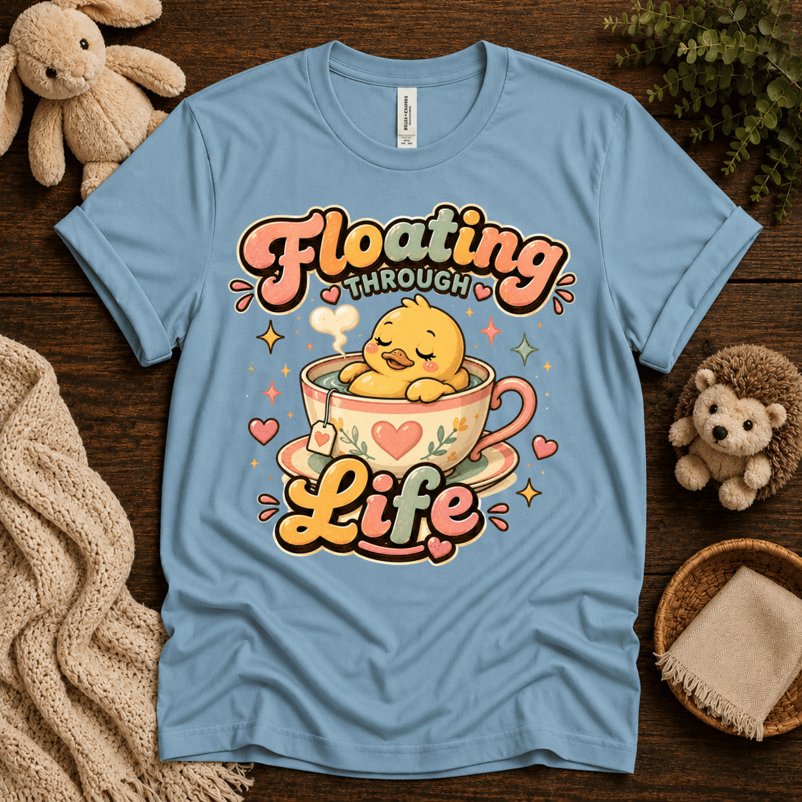 Floating Through Life cute animal graphic t-shirt cozy flat lay in baby blue.