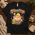 Floating Through Life cute animal graphic t-shirt cozy flat lay in vintage black.