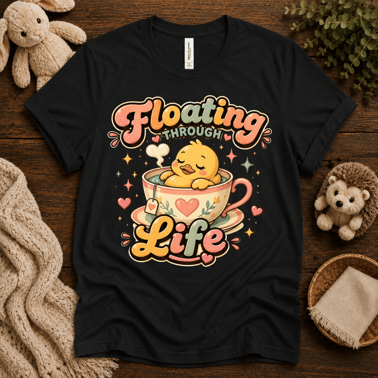 Floating Through Life cute animal graphic t-shirt cozy flat lay in vintage black.