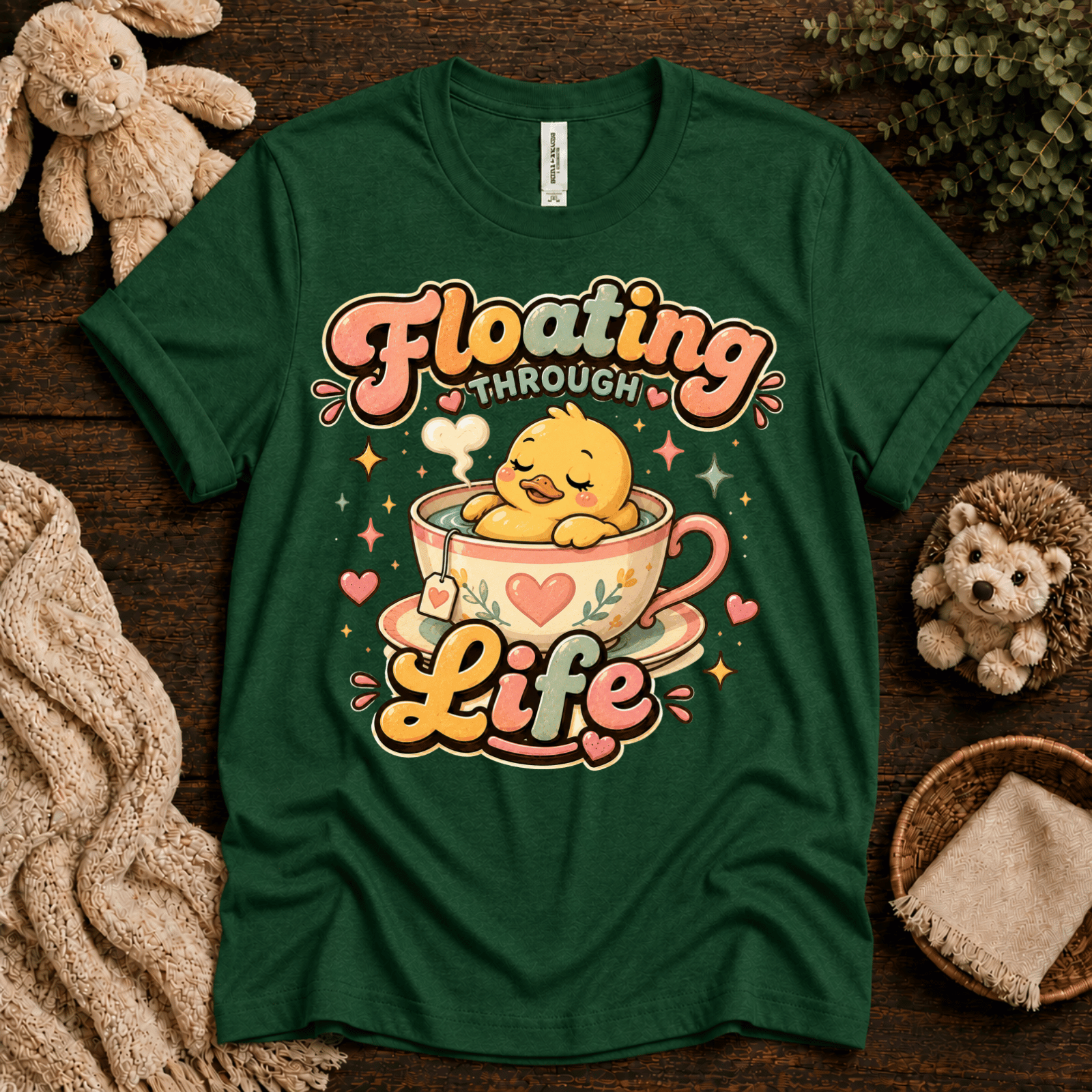 Floating Through Life cute animal graphic t-shirt cozy flat lay in evergreen.