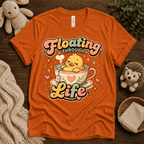 Floating Through Life cute animal graphic t-shirt cozy flat lay in burnt orange.