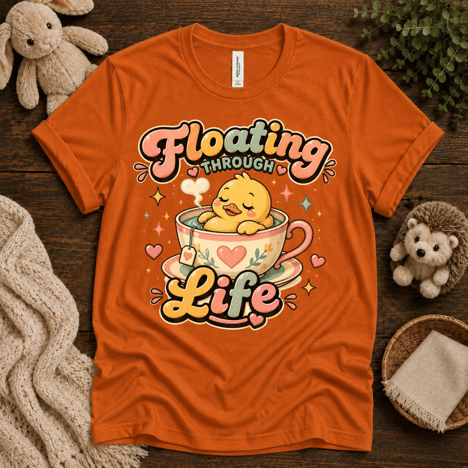 Floating Through Life cute animal graphic t-shirt cozy flat lay in burnt orange.