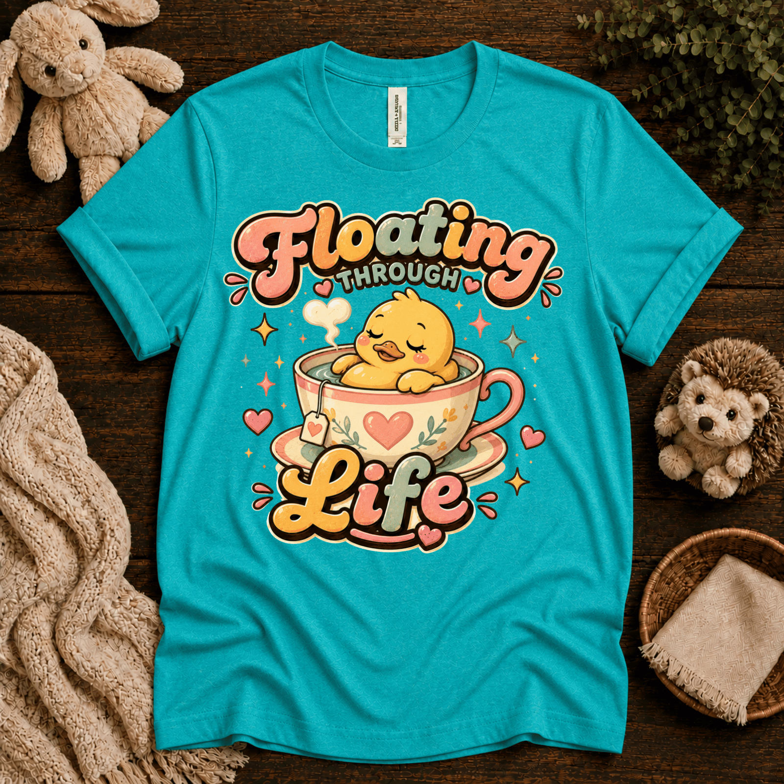 Floating Through Life cute animal graphic t-shirt cozy flat lay in heater sea green.