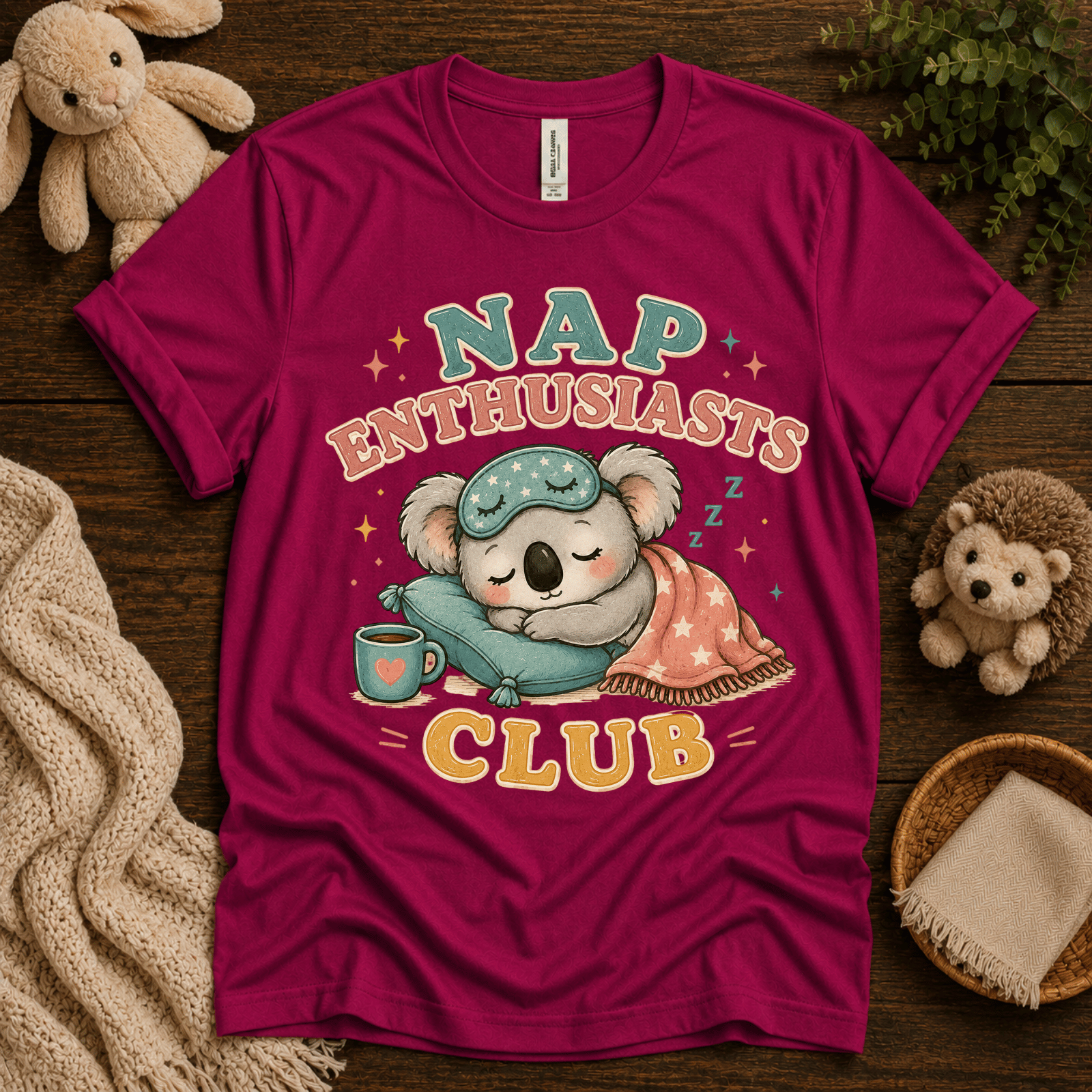 Nap Enthusiasts Club cute animal graphic t-shirt cozy flat lay in berry.
