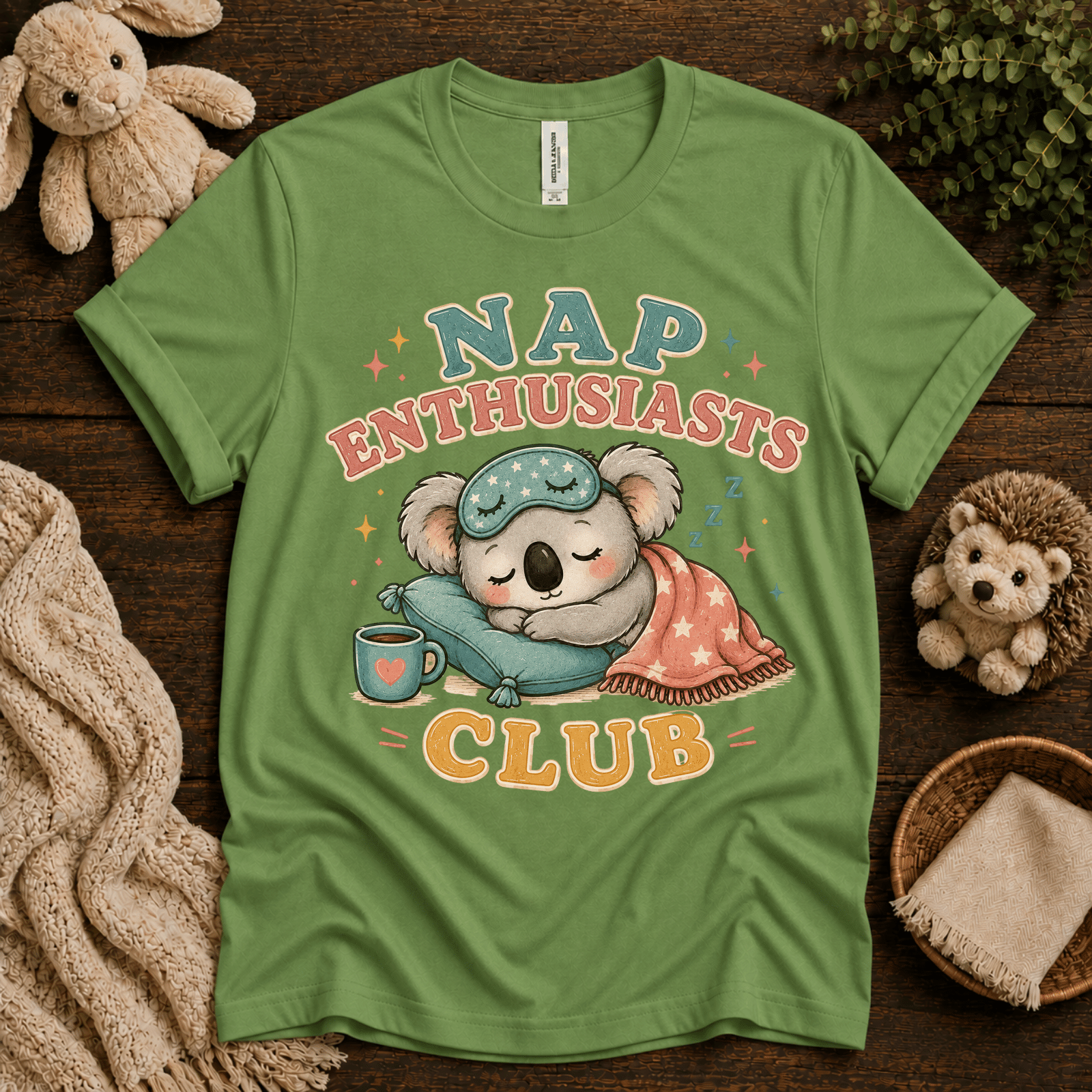 Nap Enthusiasts Club cute animal graphic t-shirt cozy flat lay in leaf.