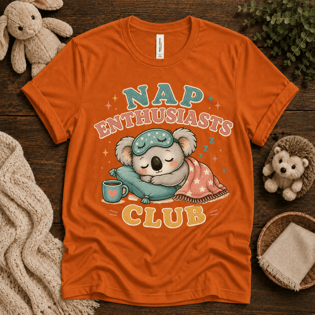 Nap Enthusiasts Club cute animal graphic t-shirt cozy flat lay in burnt orange.
