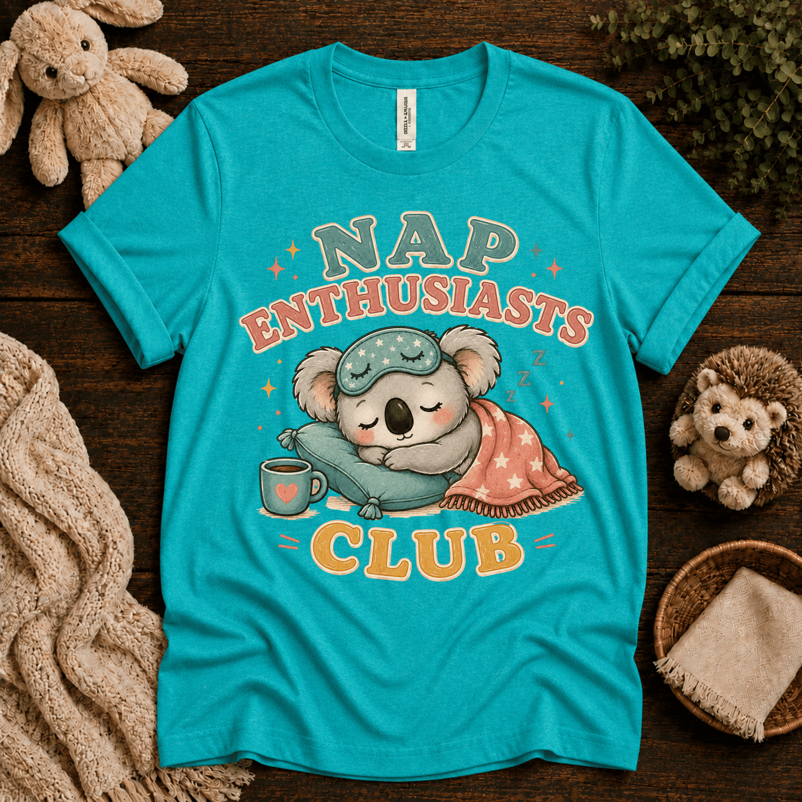 Nap Enthusiasts Club cute animal graphic t-shirt cozy flat lay in heather sea green.