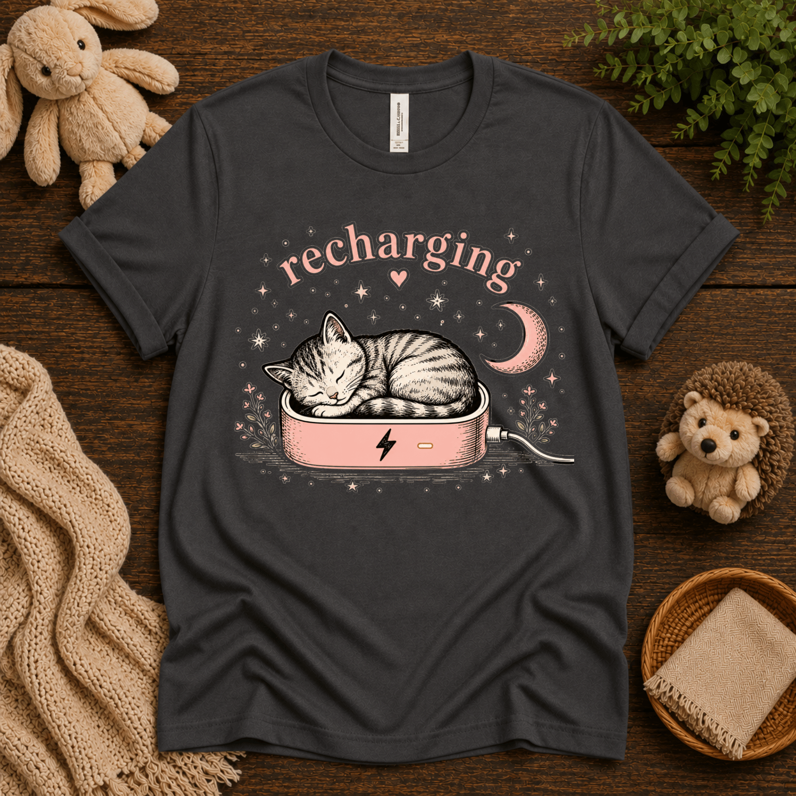 Recharging Cat cute animal graphic t-shirt cozy flat lay in asphalt.