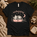 Recharging Cat cute animal graphic t-shirt cozy flat lay in vintage black.