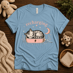 Recharging Cat cute animal graphic t-shirt cozy flat lay in baby blue.