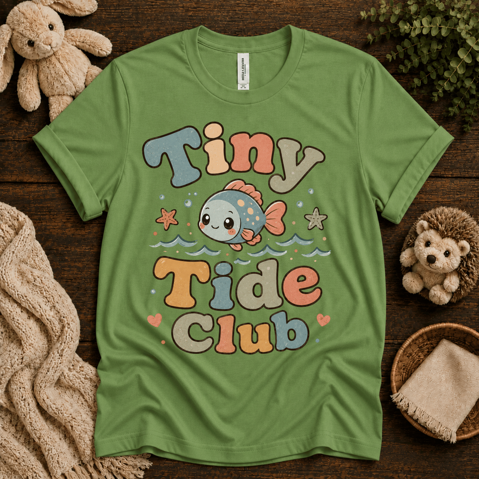 Tiny Tide Club cute animal graphic t-shirt cozy flat lay in leaf.