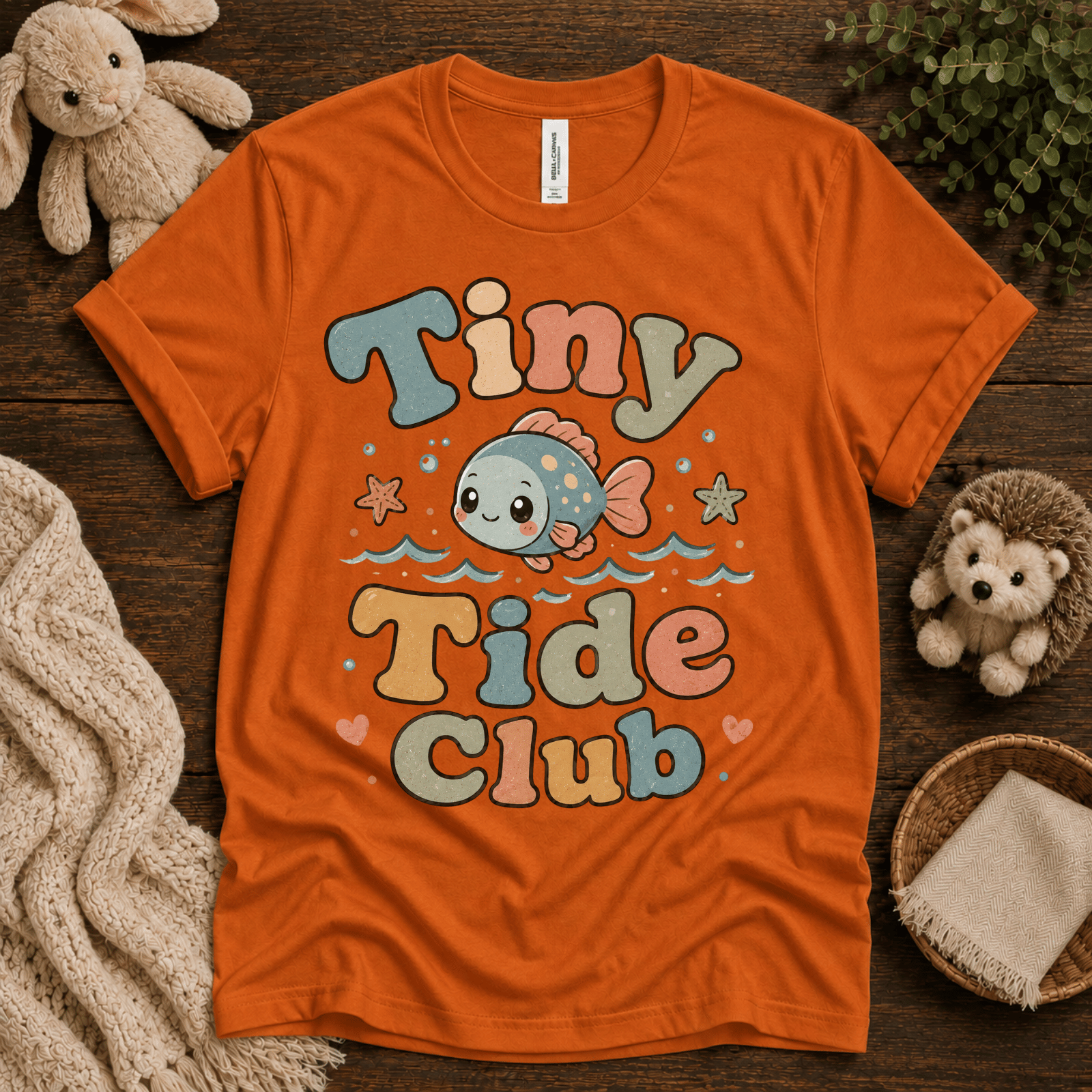 Tiny Tide Club cute animal graphic t-shirt cozy flat lay in burnt orange.